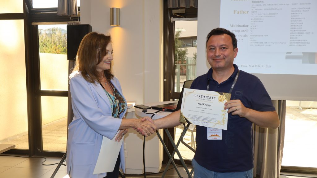4. Session Chair presenting award for best presentation to Prof. Fazil Kayikci