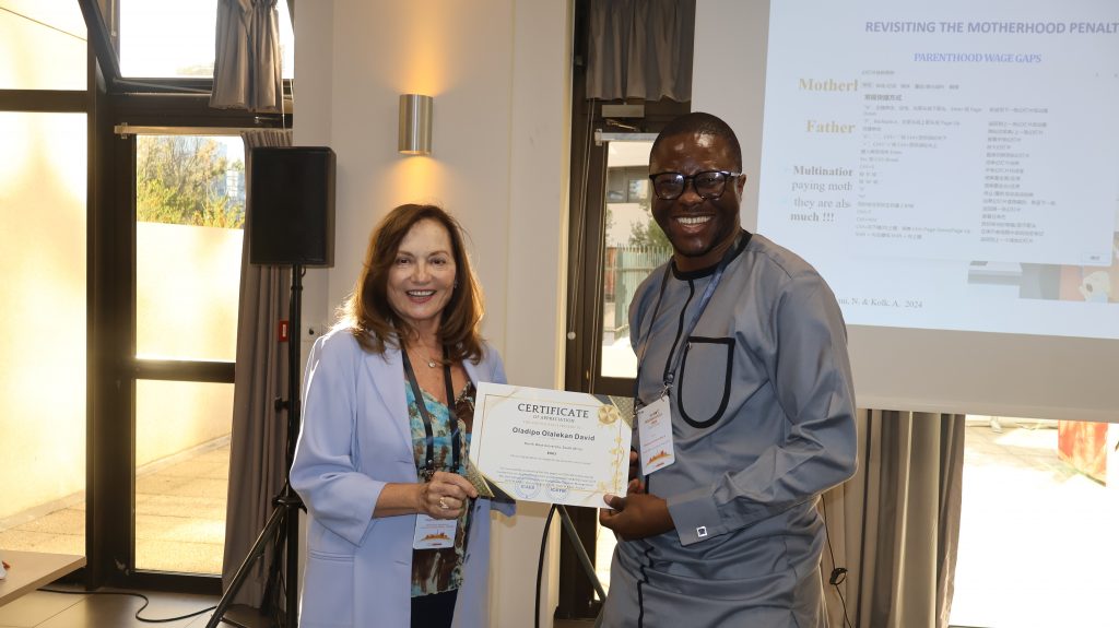 5. Session Chair presenting a Certificate to Prof. Oladip Olalekan David of North West University, South Africa